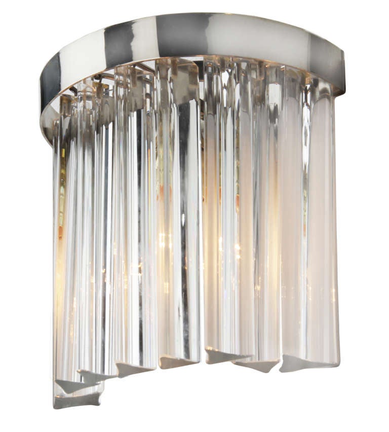 This is a pair of demilune chromed steel sconces with hanging triangulated crystals done by Venini for Camer.