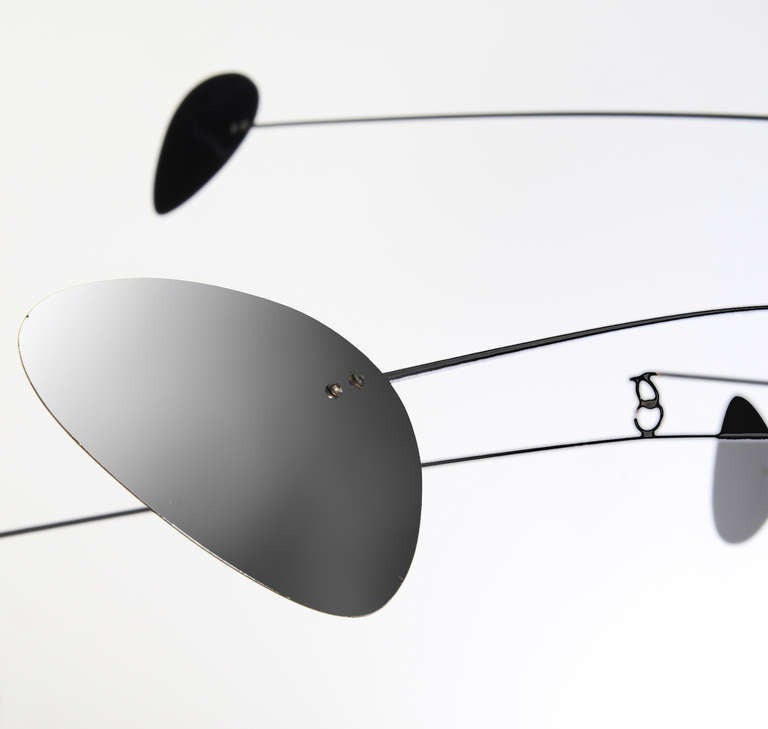 This is well proportioned and nicely mobile with metal paddles in brushed and black matt painted steel with black painted copper arms. It is signed, but illegible.