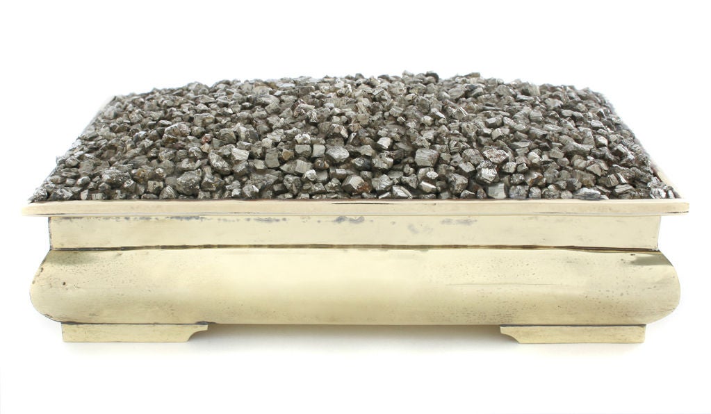 This is an unusual box. The textural pyrite plays off the classic lines of the brass box.