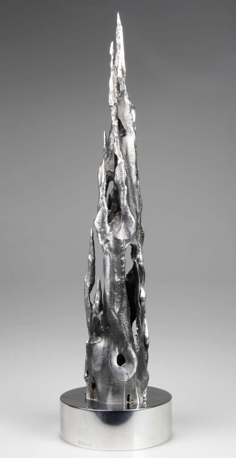 This is a  towering, flame shaped sculpture.  It is signed Hibben 1973/   This sculpture is interesting from all angles.