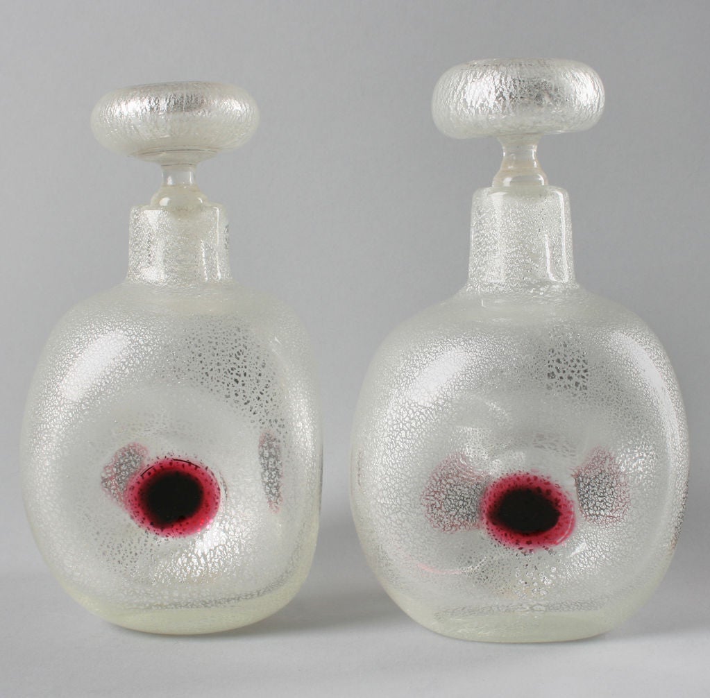 These are unusual perfumes, the body has three red  circular accents that is repeated on the stopper. These were probably done by Guilio Radi