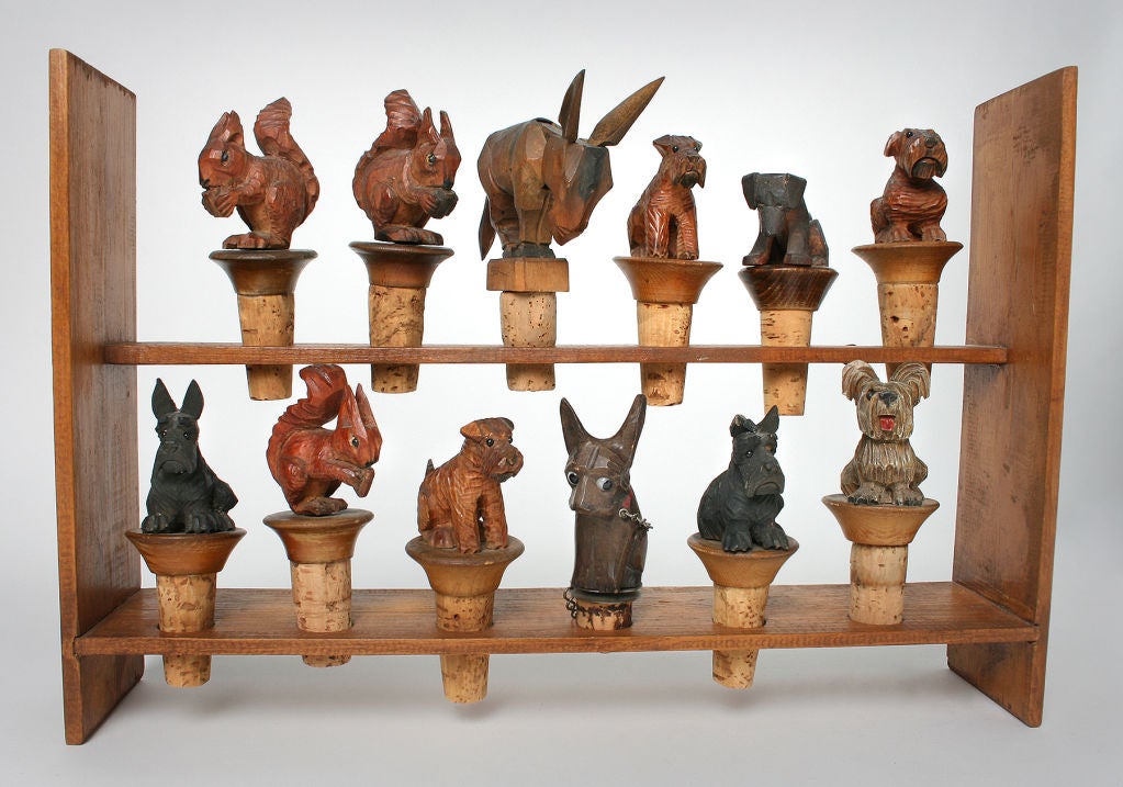 This is a charming collection of hand carved and painted figural bottle stoppers representing squirrels, dogs and a donkey.<br />
*Measuring*<br />
The wooden frame is 14