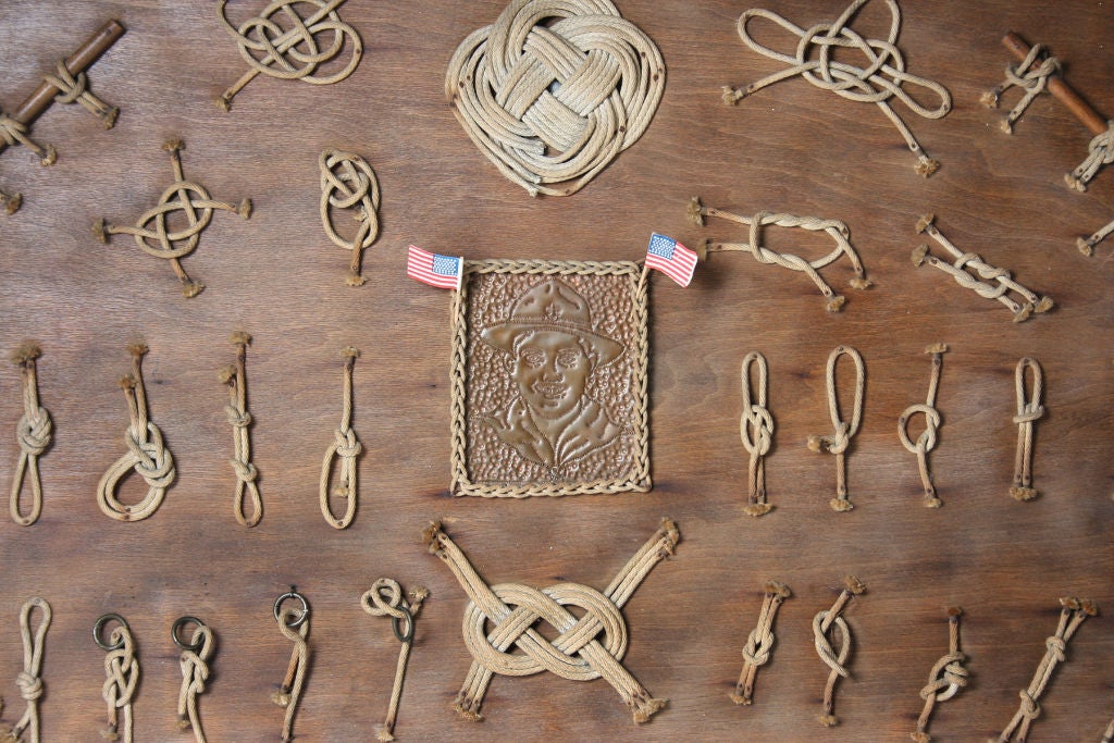 This is a great looking larger knot board. We estimate it to be from the 1930s. The American flags are not part of the board and do not come with the piece.