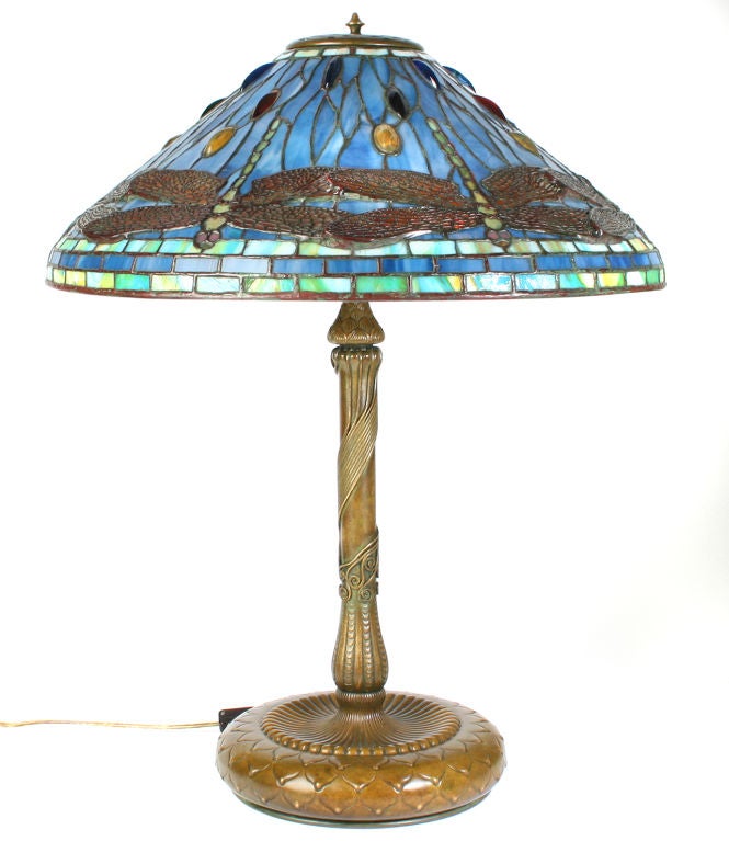 This is an incredible Tiffany Lamp.  It has a rare blue glass shade with multi colored glass jewels. The shade is 20