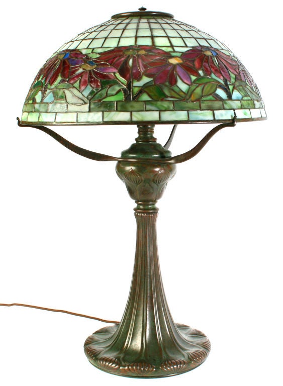 This is a very good example of Tiffany's Poinsettia lamp.  The color is very nice and rich and the bronze base has a great patina
