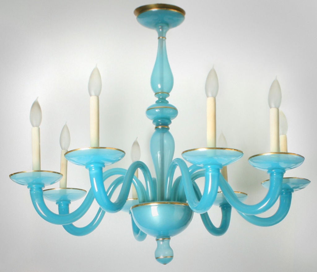 This is a beautifully colored Murano Glass Chandelier. It has eight arms and is from the 1950's. Each bobeche has a very thin accent of gold that is repeated on the stem.