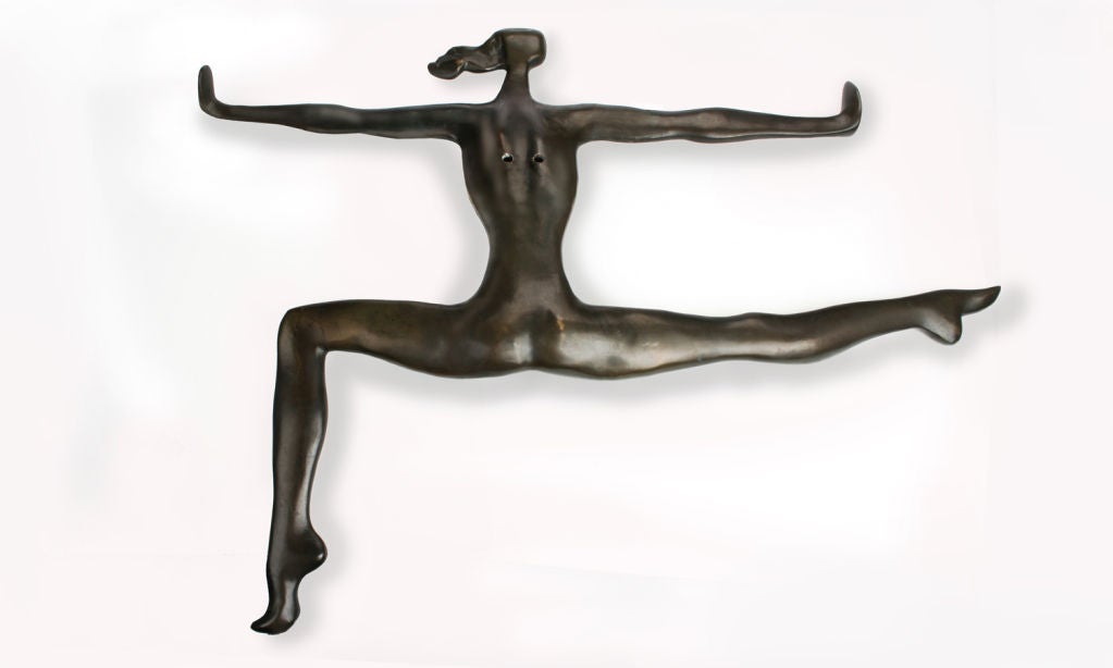 This is a modernist bronze wall mounted sculpture of a female dancer.