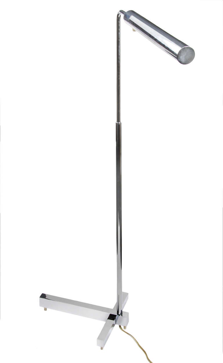 This chromed steel floor lamp  turns and pivots. The neck adjusts from 43