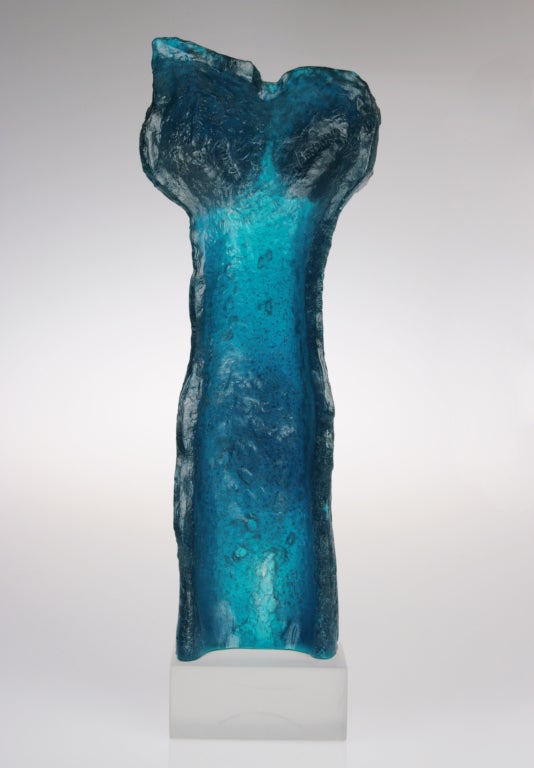 This is a limited edition pate-de-verre sculpture by Jacqueline Badord, executed by the French glass house of Daum. The color is a rich deep turquoise. This piece is numbered 125 of 150.
