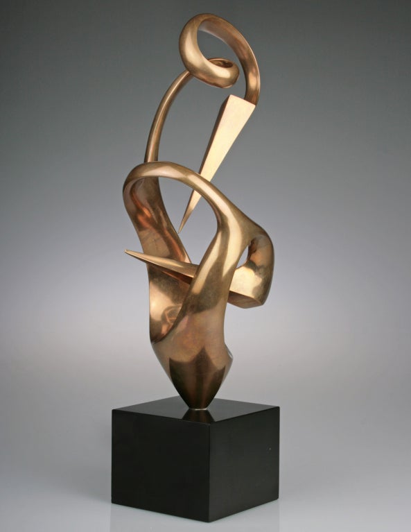 This is a handsome bronze sculpture by Spanish artist Grediaga Kieff. This piece is interesting, with a contrast between the biomorphic flow and the sharp geometric pyramidal shapes. Numbered 1 of 6 the bronze sits on a black granite base. The base