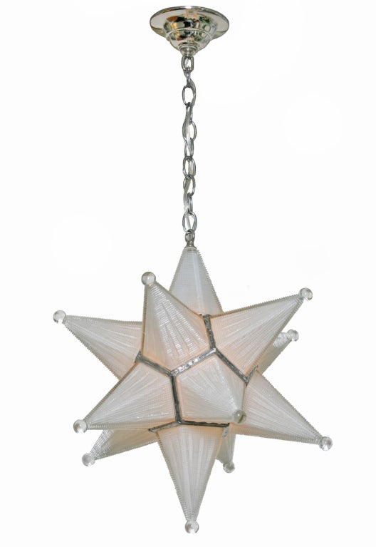 A spectacular hanging fixture made of molded textured creamy white glass, each star point culminating in a clear glass ball.  The top glass pont unlocks to allow a single bulb. The chain measures 14