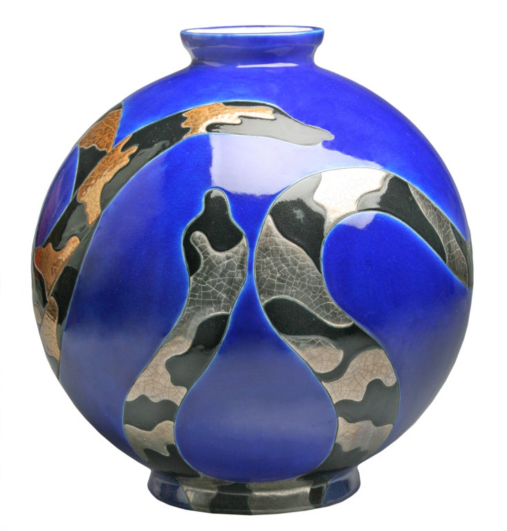 This is a  large and striking boule vase with two intertwined snakes. Designed in the Art Deco style by Danillo Curetti, it is number 3 in the edition. These were produced in limited editions.  Curetti worked for Longwy in the 1980's.  He died in
