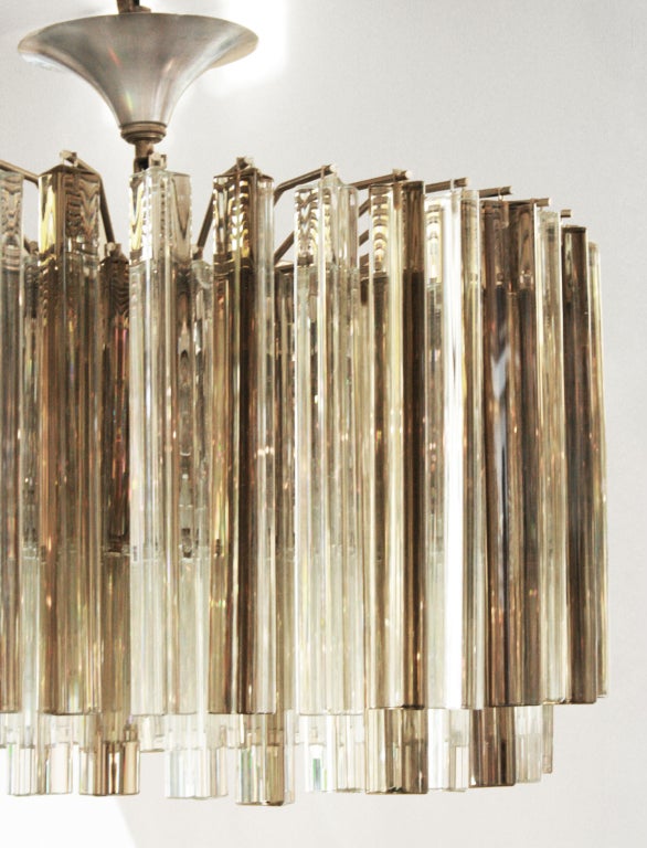 This is a handsome chandelier with triangular clear and smoked crystals. Uses six standard bulbs.