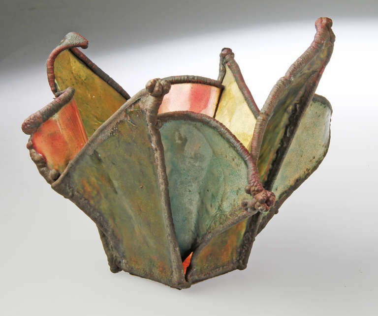 This is a multi-colored enamel sculptural bowl  by artist June Schwarcz, a major force in enamelling. Born in 1918, Schwarz is in the Museum of Art and Design, the Renwick,Gallery, The Museum of Applied Arts in Zurich and many others.  She was