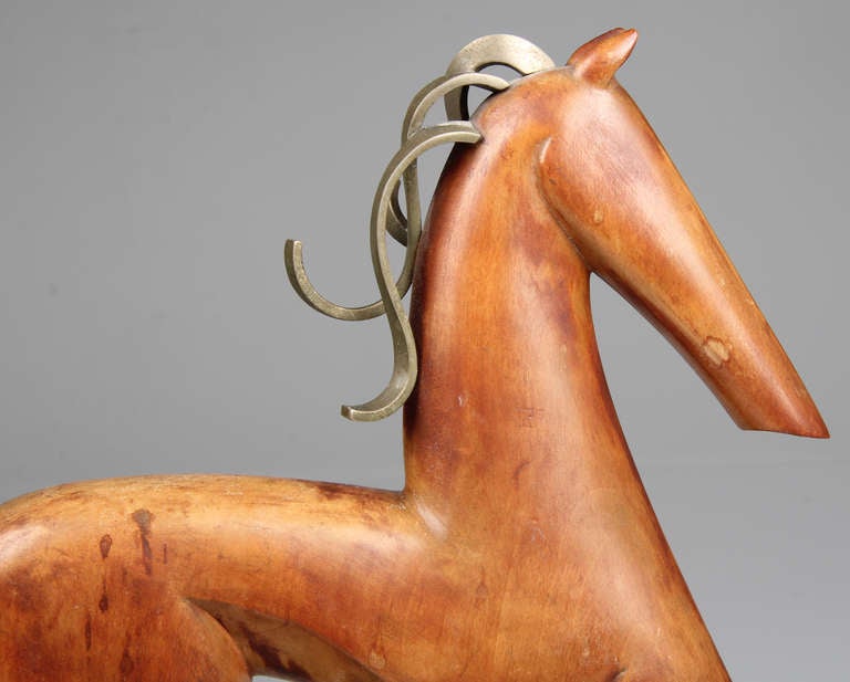 Signed SK in a triangle on the bottom, this carved wood horse resembles the work by Hagenauer.