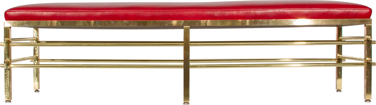 This is an interestingly designed, high quality bench, having squared brass legs contrasting with round brass struts. It was recently polished and reupholstered in red leather and is ready to go.