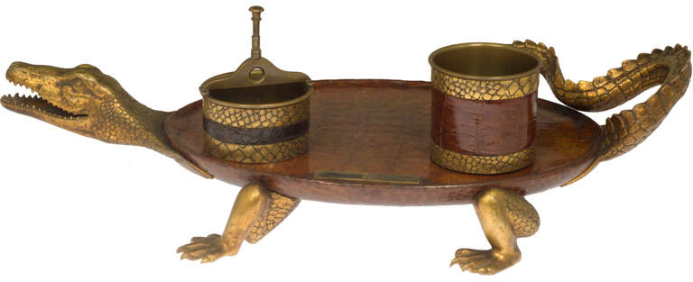 This is a fabulous set. The image of the alligator is rendered beautifully.
On the tray there is a match striker, a container for ashes and one for cigarettes. As you can see, the receptacles have an engraved alligator pattern complimenting the