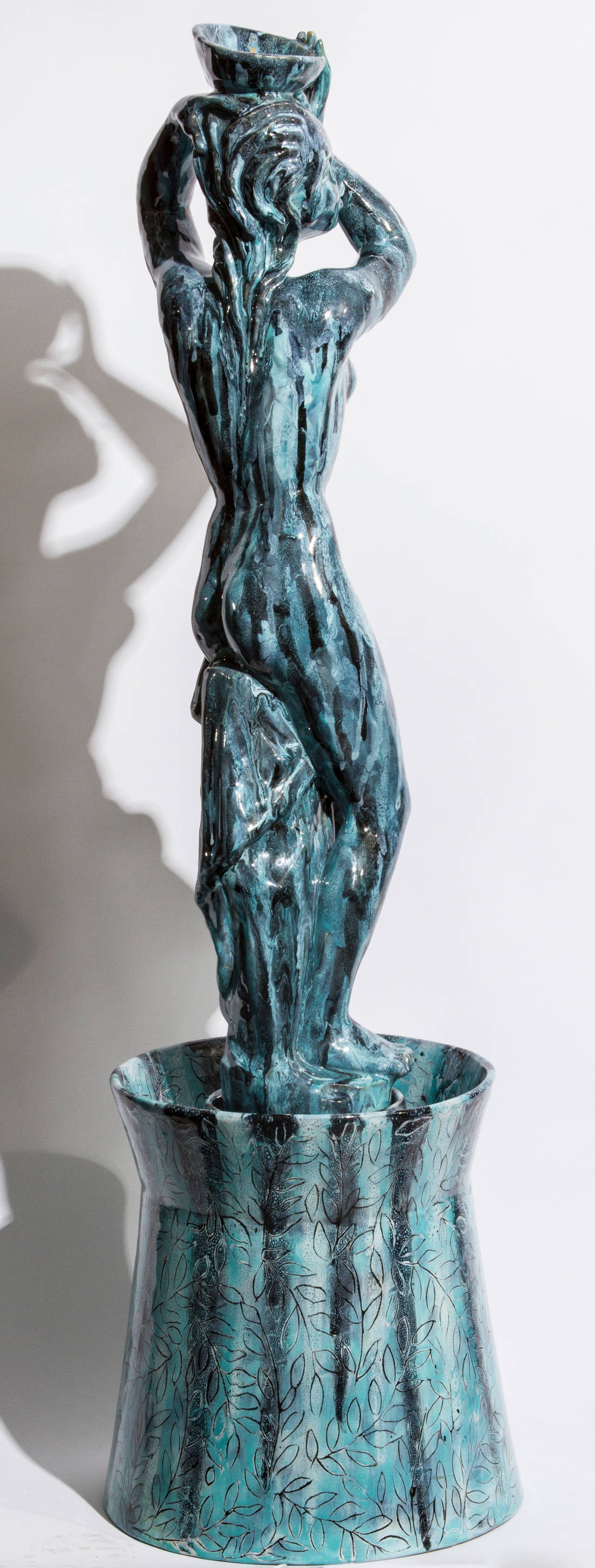 This piece features a maiden with a liquid blue glaze bathing in the water.