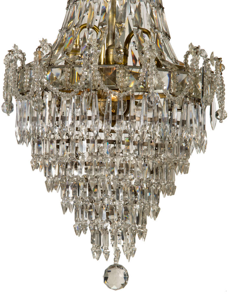 This is a beautiful chandelier with interesting cut crystals, with a draped crystal detail.  It takes four bulbs.
