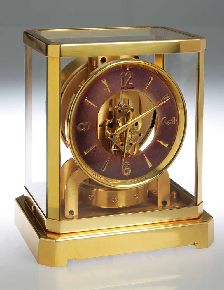 This clock self winds by changes in the barometric pressure. The color of the face is a light aubergine.