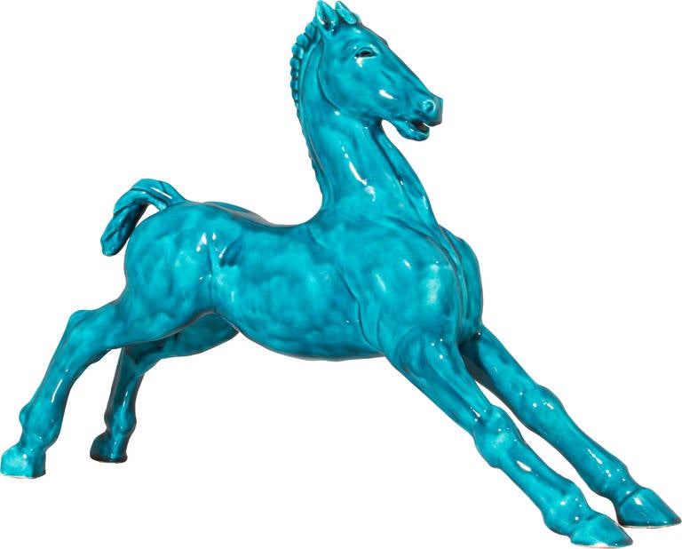 This is a beautiful and large Art Deco Colt, seemingly playful in a most beautiful turquoise colored glaze.
