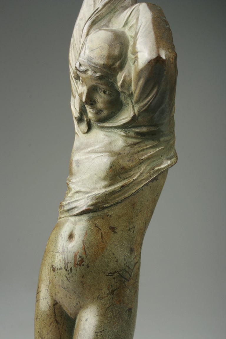 This is a beautiful bronze  of a young woman taking off her dress. Sculpted by Francois Auguste Clemencin,(1878-1954.)  This piece in French is  called Filette Otant sa Chemise.