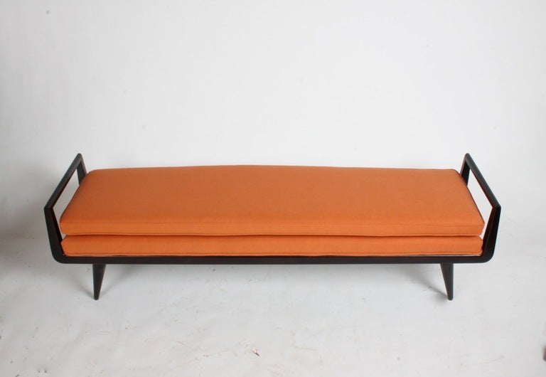 1950's bench with handle sides in mahogany with a dark brown finish, new upholstery in a burnt orange linen.