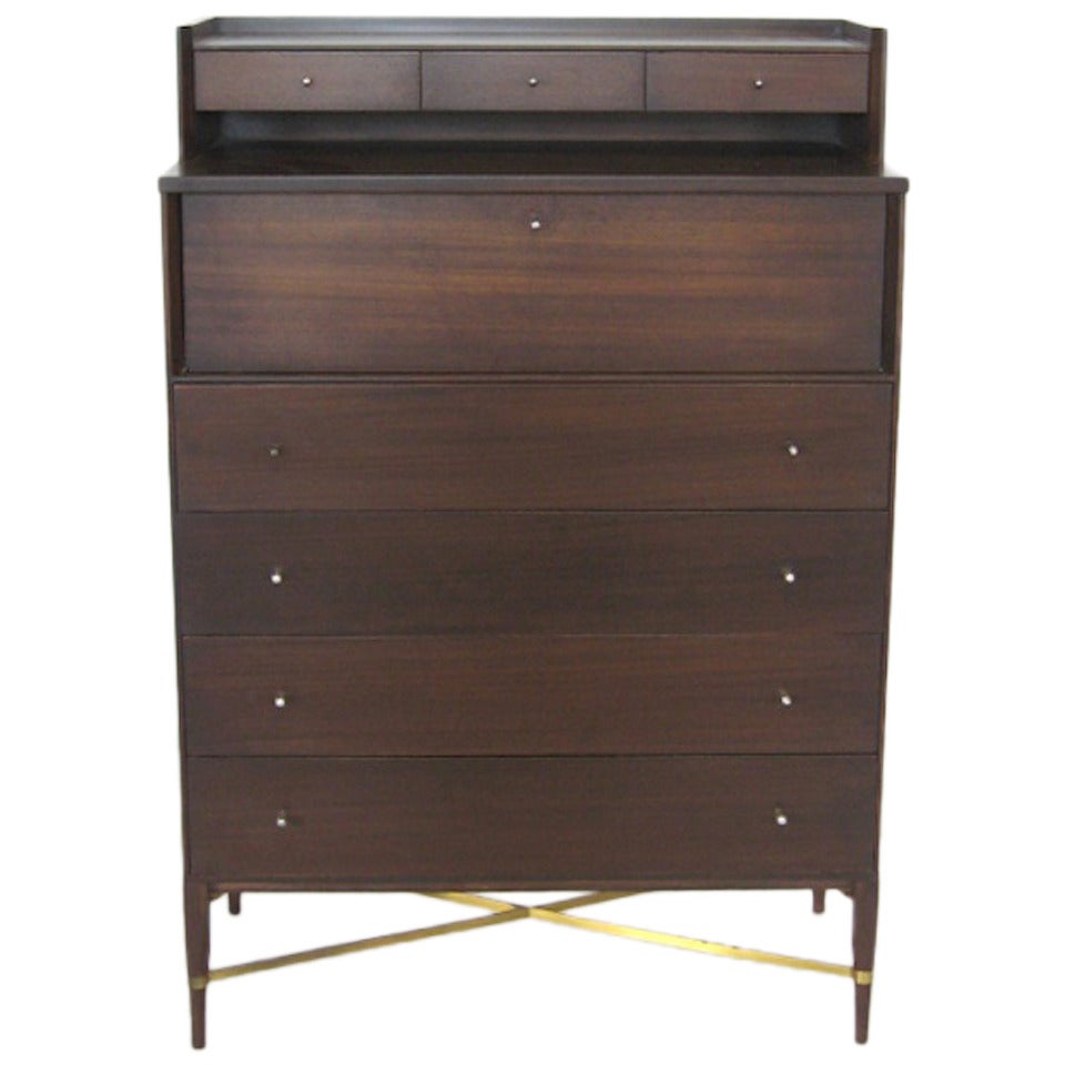 One of Paul McCobb's most desirable designs, rare model 1013 gentleman's chest of drawers or tall dresser in mahogany from the Calvin group. Elegant and stately, it is loaded with refined details. A bank of three shallow drawers floats above four