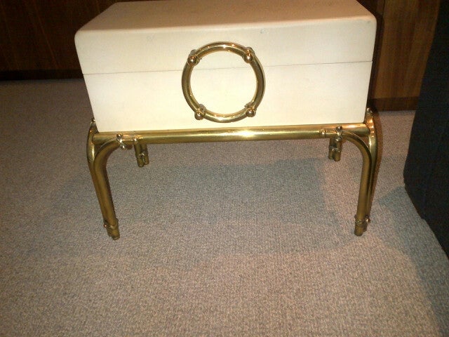 Parchment colored lacquered chest with brass hardware and base.