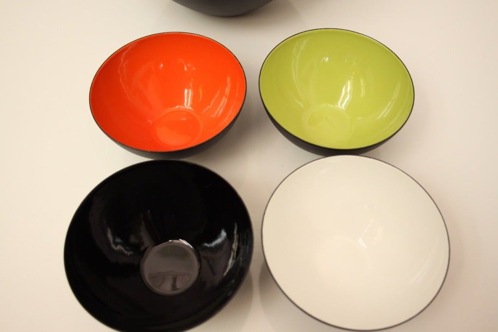 Herbert Krenchel  set in unused or near mint condition mid-century / Danish modern bowls, a large matte glaze bowl with enameled green interior and four en suite smaller bowls with red, black, white and green interiors and set of salad servers.