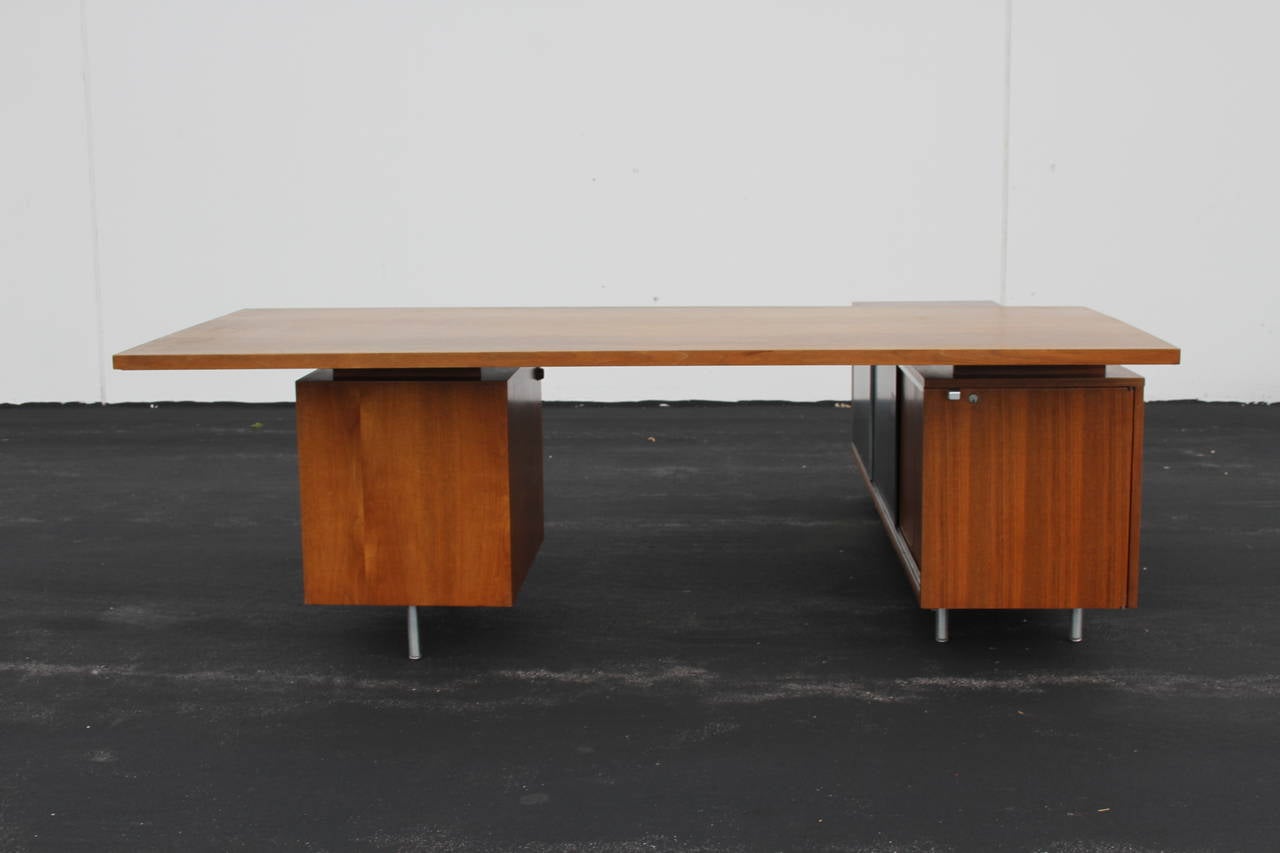 Midcentury George Nelson for Herman Miller walnut desk, 
To be refinished, has label and electric cord, original key 
(modesty panel can be made), rare trash can option, spring top, but original can is missing
measurements:
Overall: 84