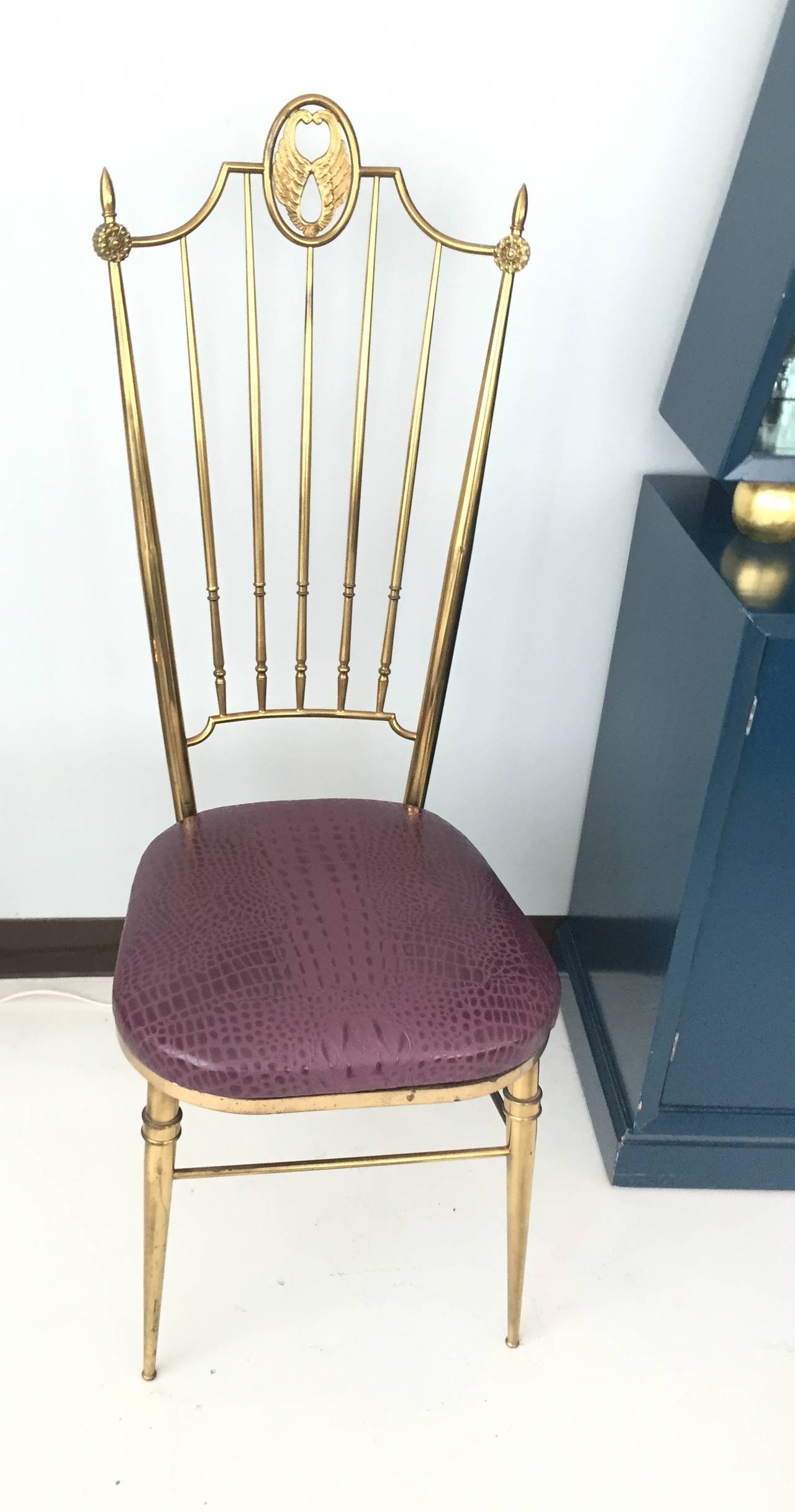 Chiavari style, Tall back Italian side chairs with brass frames, seats in aubergine embossed leather in crocodile pattern. Would work well as a vanity or desk chair. Brass has overall patina with darker spots. Price per chair, pair available