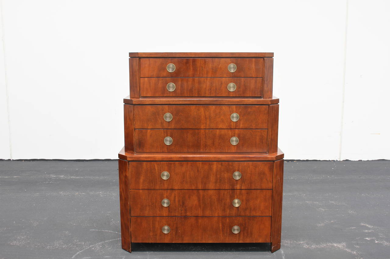 A limited production tall skyscraper chest of drawers designed by Charles Pfister, concentric brass circles that pivot as drawer pulls, circa 1990. Primavera mahogany.