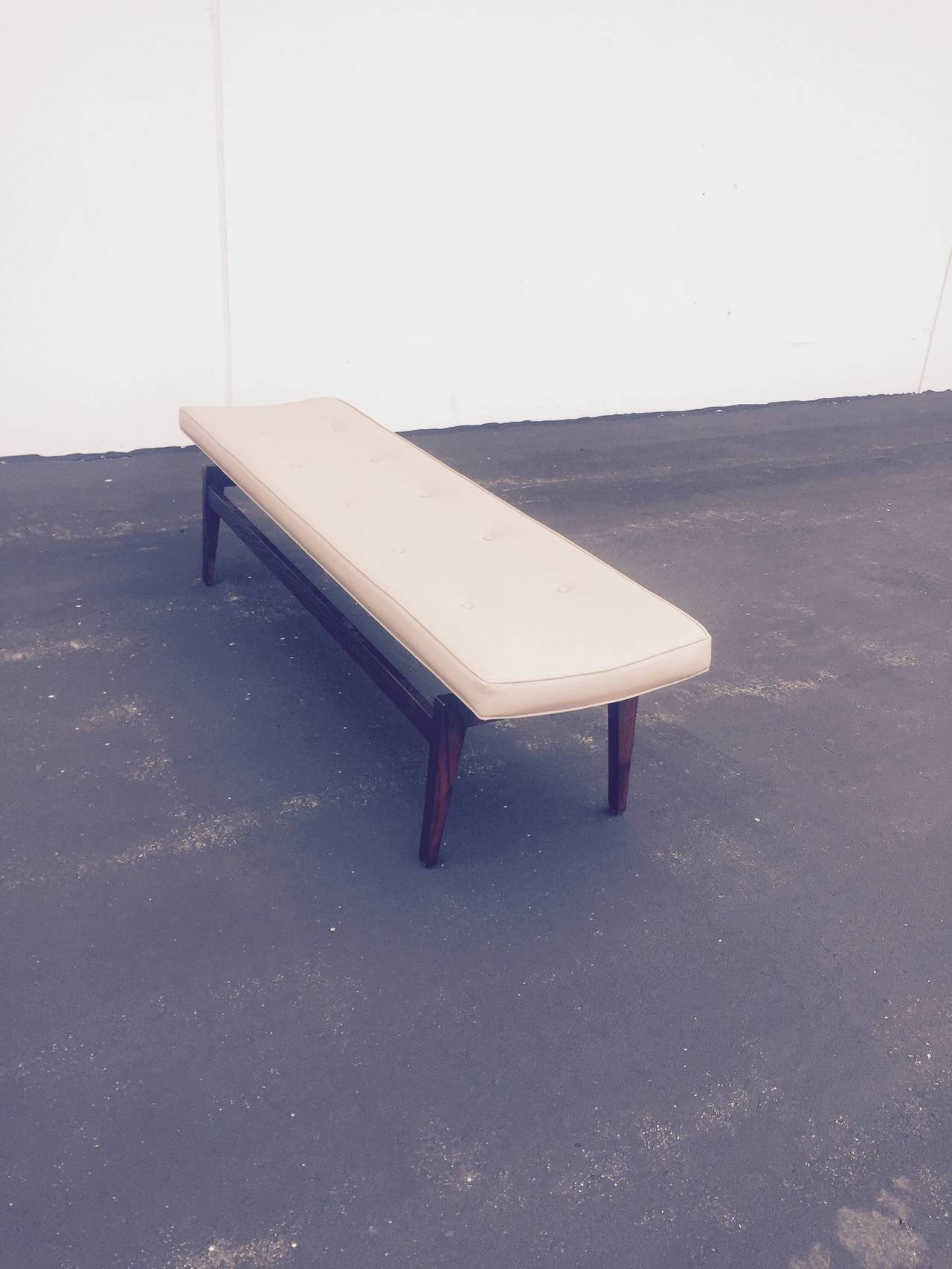 6 ft bench with slightly concave seat and walnut base in medium dark stain, in the manner of Jens Risom but at 18