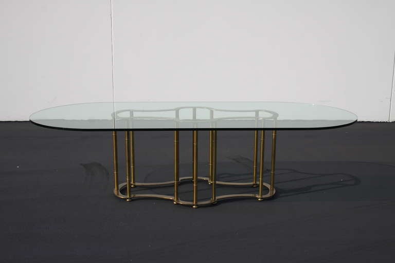 brass racetrack dining table with oval glass top