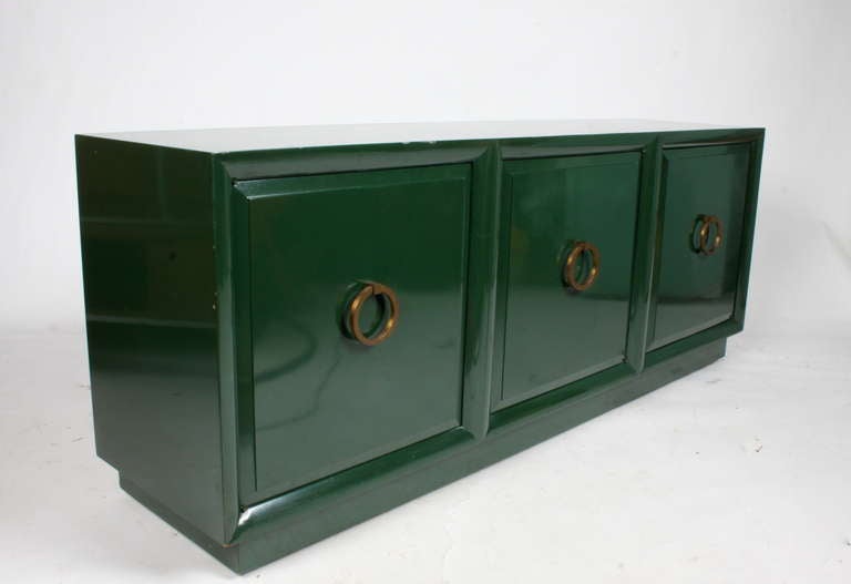 Three door cabinet with brass ring hardware designed by T. H. Robsjohn-Gibbings for Widdicomb. Could be used as a console or a media cabinet, price includes refinishing, can be done in custom color