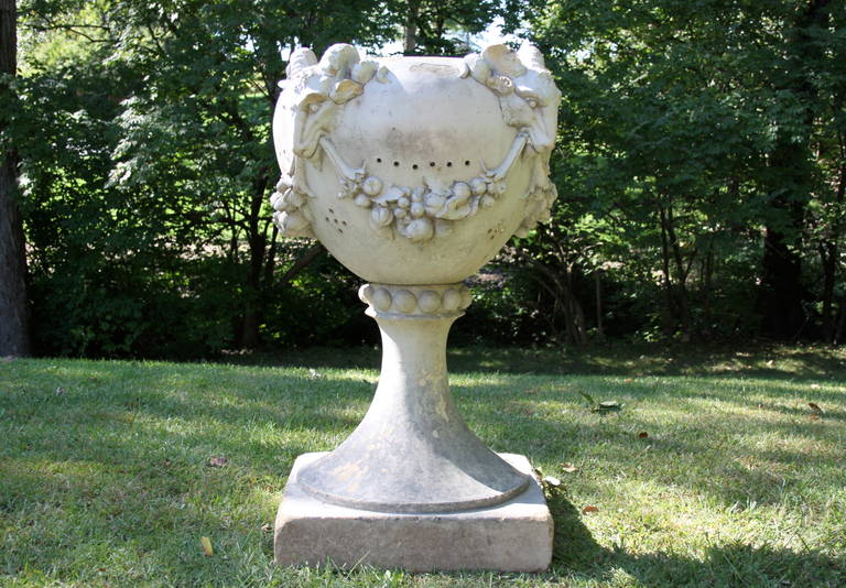 Large and elegant terra cotta planter, two pieces. A rod runs through the base into the urn at the top to give stability, interior with drain holes. Please note losses (mostly to one side) 16