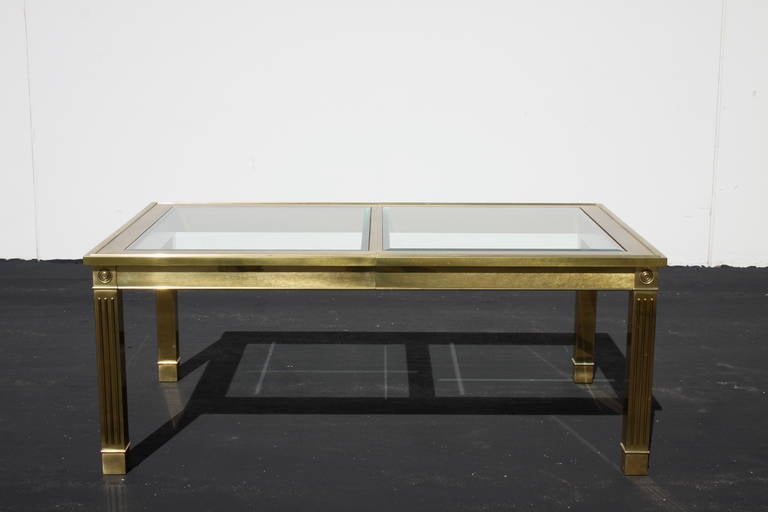 Brass dining table with architectural legs and glass inserts, paper label, no leaf.