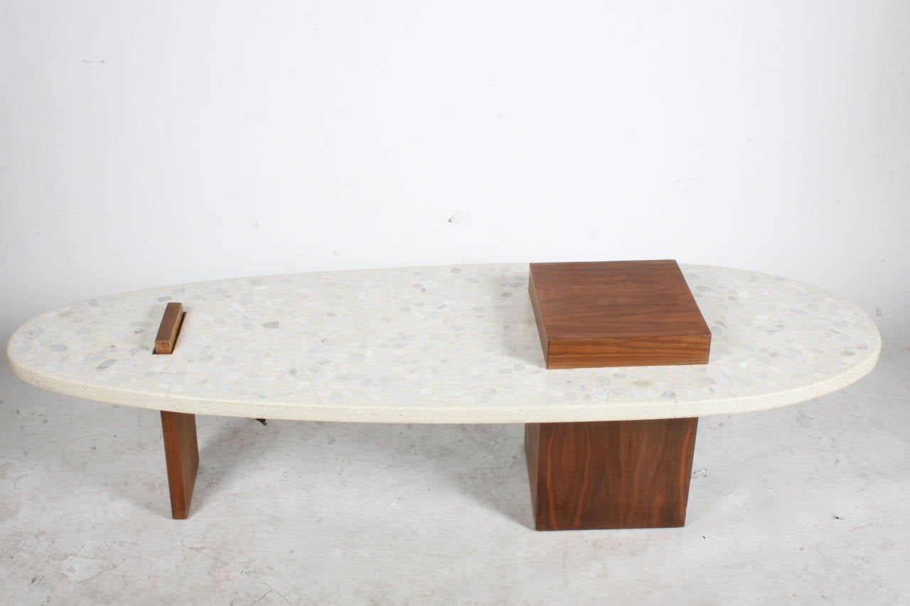 Sculptural coffee or cocktail table with walnut supports and terrazzo top, in the style of Harvey Probber
17.5 H of support x 22 W x 66.5, top is 15 H.
Top 1-3/8 thick over wood, couple of stress cracks to terrazzo but they don't go all the way