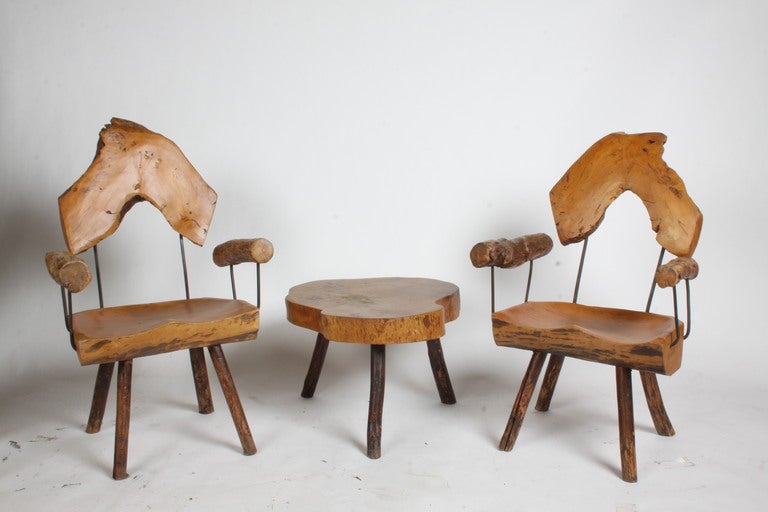 Midcentury / Folk Art carved logs armchairs with iron supports and matching side table. Table measures: 23