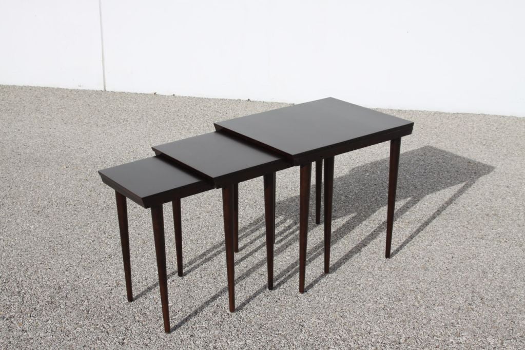 Set of three Russel Wright for Conant Ball nesting tables, rectangular tops with tapered dowel legs. Newly refinished in a dark brown finish. Very nice restored finish. 

Measurements : 
Large 20.5 W x 26 D x 24 H.
Medium: 17 W x 25.5 x 23
