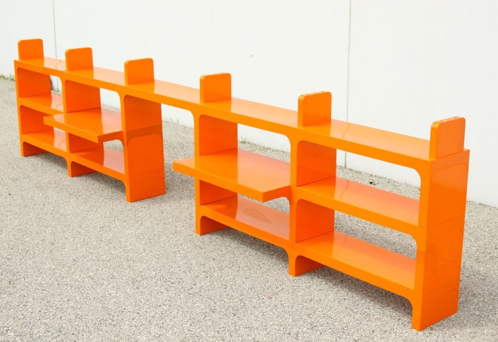Orange plastic modular bookcase with multiple component parts that can be assembled in various ways. As shown: 13 feet long by 36