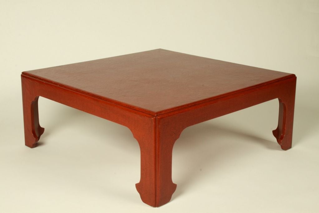 Baker cocktail table in Asian Modern form with red embossed leather with crackle finish.