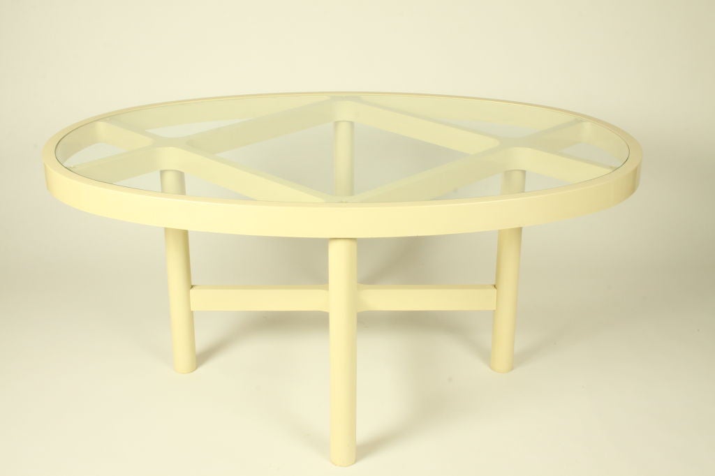 Oval dining table with glass inset top and ivory plastic base with lattice design on top, possibly Kartell.