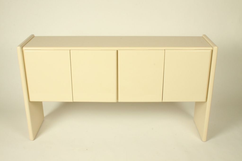Milo Baughman for Thayer-Coggin four-door sideboard, ivory lacquer, drawers on the left side, glass shelves on the right. Label on verso. 