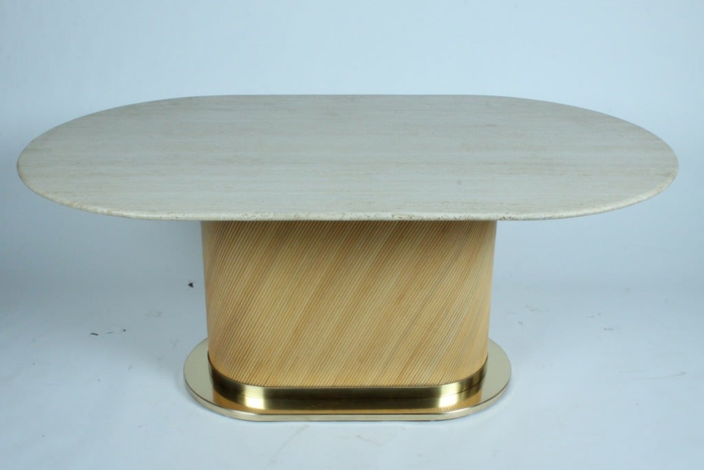 Travertine oval top dining table with pedestal of brass and rattan, made by Bielecky Bros. NYC
