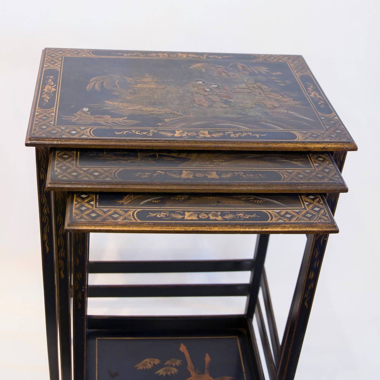 Set of Three English Chinoiserie-Decorated Nesting Tables, circa 1870. The smallest with decorated medial shelf. The largest measures: Width: 20.5, Height: 28.25 in., Depth: 13.75