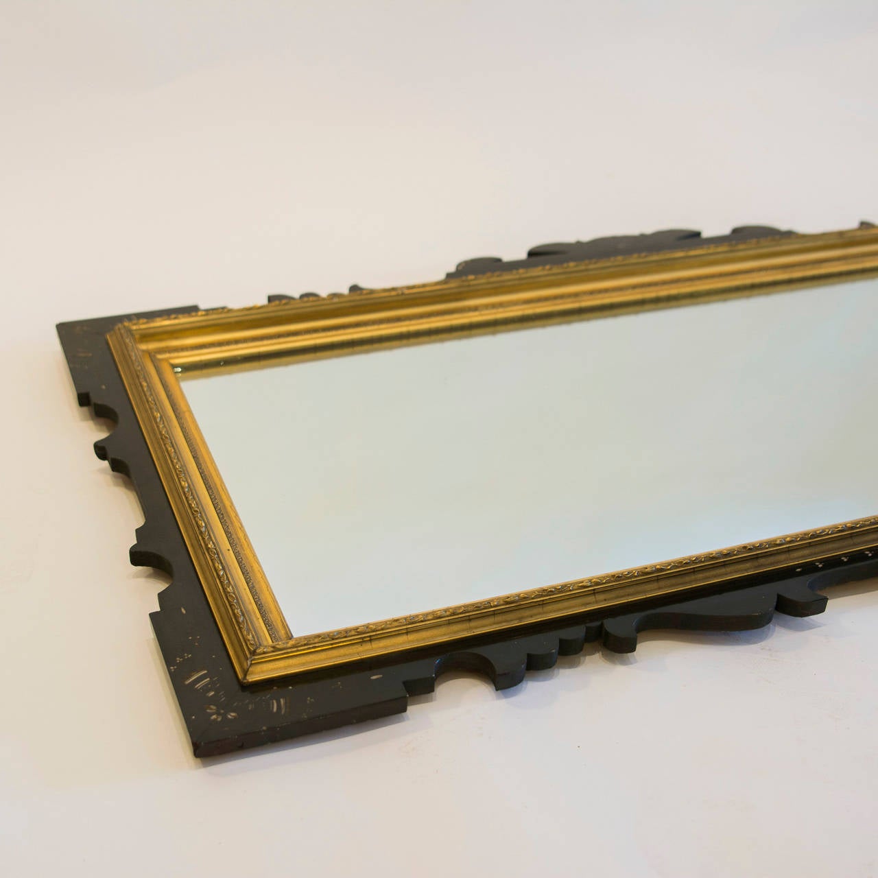 Aesthetic Movement Gilt and Ebonized Overmantel Mirror with Finely Incised Decoration highlighted in off-white. circa 1880
Width: 41¾ in., Height: 22 in ., Depth: 2½ in