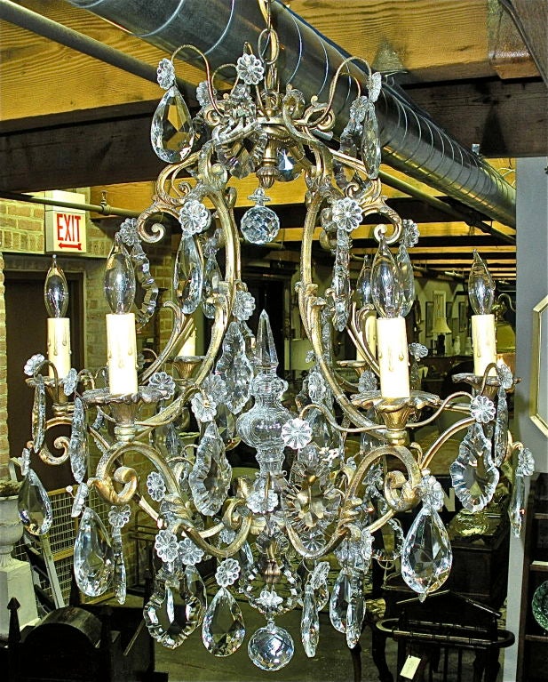 1850's single tier of lights highlight predominantly teardrop crystals and blown glass inner column