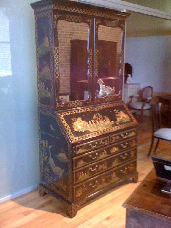 Lacquered, gessoed and handpainted chinoiserie decoration on George II bureau bookcase; original mirrored doors open to three adjustable shelved; bureau opens to fitted interior with exceptional flat drawers and is over two short and three